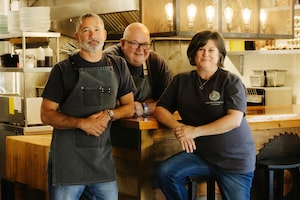 Heartwood Kitchen owners (from left to right) Anthony Pugh, Ian Riddick and Heather Riddick pose inside their restaurant in Ucluelet, British Columbia, on June 11, 2026. Photograph by Melissa Renwick