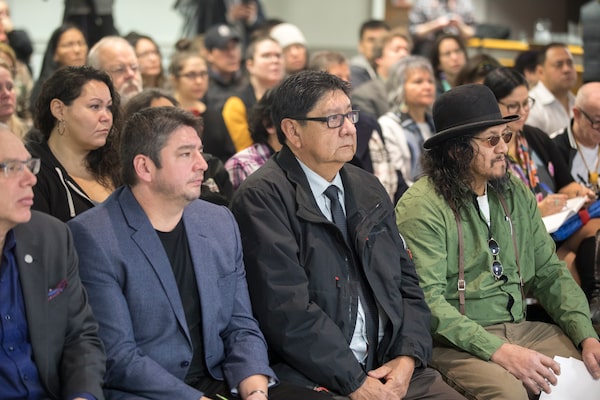 Rainy River First Nations Chief Jim Leonard, centre, sits with Brad DeBungee, right, while the Independent Police Review Director, Gerry McNeilly, presents his systematic review of the Thunder Bay Police Service, titled 'Broken Trust', at the DaVinci Centre in Thunder Bay, Ontario. DeBungee's brother, Stacy, was found dead in the McIntyre Floodway on October 19, 2015. David Jackson/ Globe and Mail