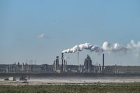 A general view shows a Syncrude oil sands mining facility near Fort McKay, Alberta, on September 6, 2022. - At Fort McKay near Fort McMurray in western Canada, in the heart of the country's boreal forest, the pines and the people were long ago cleared out to make way for huge open-pit mines dedicated to excavation of oil sands. (Photo by Ed JONES / AFP) (Photo by ED JONES/AFP via Getty Images)