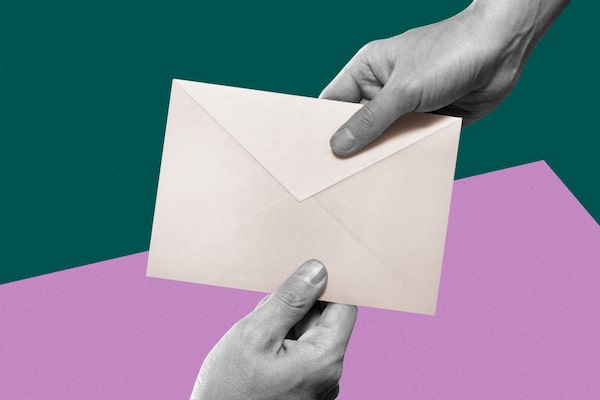 Woman's hand giving an envelope to a man's hand