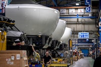 CAE employees work in the CAE manufacturing plant in Montreal on December 11, 2025.  