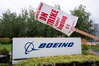 FILE PHOTO: A strike sign hangs from a post near a Boeing sign as Boeing factory workers and supporters gather on a picket line during the third day of a strike near the entrance to a Boeing production facility in Renton, Washington, U.S. September 15, 2024.  REUTERS/David Ryder/File Photo