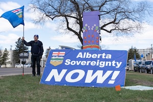 A separatist supporter holds a flag during a rally near the Elections Alberta headquarters in Edmonton last week.