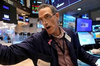 Trader Gregory Rowe works on the floor of the New York Stock Exchange, Friday, Aug. 16.