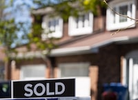 A real estate sign is posted outside a home in Pointe-Claire, a city in Montreal's West Island, Tuesday, May 7, 2024. THE CANADIAN PRESS/Christinne Muschi