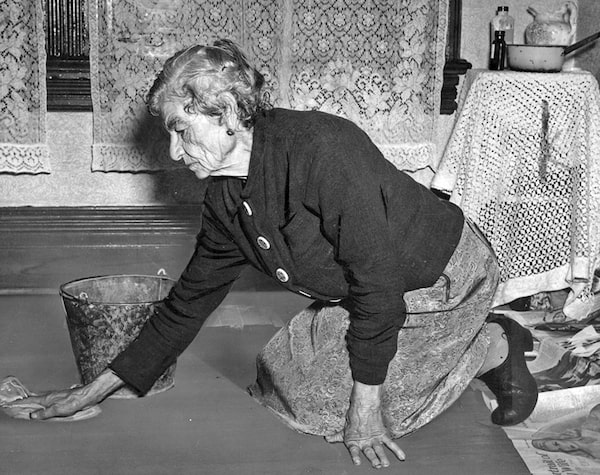 Old age pensioner scrubbing floors to supplement her allowance, June 1947. Credit: Canadian Tribune / Library and Archives Canada