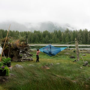 Annie Lax swings her friend on a hammock during Robinson Cook’s birthday party on Calf Island on June 11, 2024. Mr. Cook lives on the small island that’s a short boat ride from Tofino with his partner, Mary Forest.