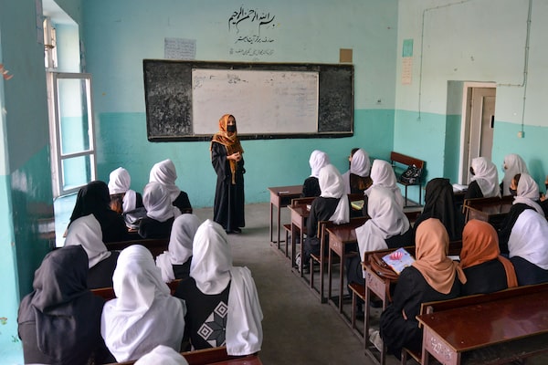 Girls attend a class after their school reopened in Kabul on March 23, 2022. - The Taliban ordered girls' secondary schools in Afghanistan to shut on March 23 just hours after they reopened, an official confirmed, sparking confusion and heartbreak over the policy reversal by the hardline Islamist group. (Photo by AHMAD SAHEL ARMAN/AFP via Getty Images)