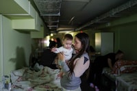 Marharyta Nekhoroshyva holds her son Mark inside a shelter at the children's regional hospital of Zaporizhzhia, Ukraine, on Thursday, May 7, 2026. (AP Photo/Evgeniy Maloletka)