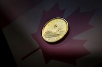 FILE PHOTO: A Canadian dollar coin, commonly known as the "Loonie", is pictured in this illustration picture taken in Toronto January 23, 2015. The Canadian dollar strengthened against the U.S. dollar on Friday after Canadian CPI data showed an increase in core inflation. REUTERS/Mark Blinch/ File Photo