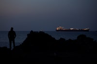 The Parnassos crude oil tanker sits anchored in Muscat, Oman, on Tuesday amid a virtual standstill in the Strait of Hormuz.