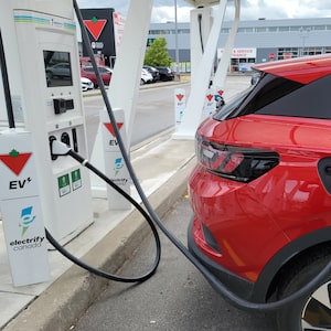A 2022 Volkswagen ID.4 EV is shown at a charging station at a Scarborough, Ontario Canadian Tire on Wednesday June 14, 2023. Statistics Canada says sales for electric vehicles were up 53 per cent in the first quarter, compared to the same time year. THE CANADIAN PRESS/Doug Ives