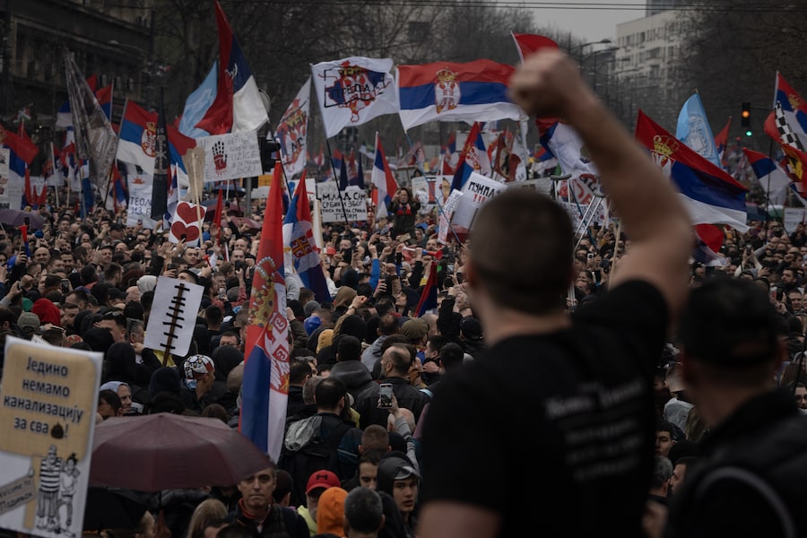 People chant as they march in an anti-government protest near the Serbian parliament and the president’s office in Belgrade.