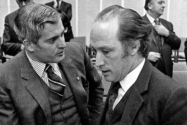 Prime Minister Pierre Trudeau and Federal Justice Minister John Turner share a brief word during a break in the Constitutional Conference on Feb. 8, 1971. (CP PHOTO/ Chuck Mitchell)