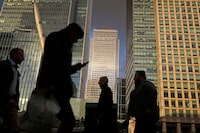FILE PHOTO: People walk through the Canary Wharf financial district of London, Britain, December 7, 2018. REUTERS/Simon Dawson