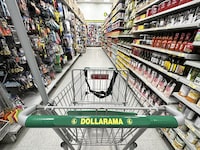A shopping cart is seen in an aisle of a Dollarama store in Montreal, Wednesday, June 7, 2023.  