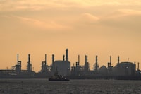 TEESSIDE, ENGLAND - MARCH 09: A tug boat sales up the River Tees past the ConocoPhillips oil terminal on Teesside on March 09, 2026 in Teesside, England. Global oil prices have risen to their highest levels since 2022 following an escalation of the US-Israel war with Iran. Brent crude, the international benchmark, surged past the $100 psychological threshold. Liquid Natural Gas (LNG) prices have also seen a 50% increase since the US and Israel attacked Iran. The war has  effectively closed the Strait of Hormuz  which sees over a fifth of the global oil and LNG trade pass through narrow gulf. (Photo by Ian Forsyth/Getty Images)