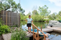 Barb Daize-Mason on her cottage dock along Gull River in Minden, Ontario. Daize-Mason is looking to sell her property due to a significant increase in maintenance cost. July 3rd, 2026. (Liv Talarico/The Globe and Mail)