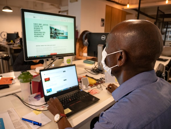 GA, a refugee who works for Justice Centre Hong Kong, sits at his desk at the organisation's headquarters in Sai Ying Pun, on Hong Kong Island.