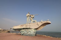 A sculpture overlooking the Strait of Hormuz is seen along the seafront in the port city of Bandar Abbas, in southern Iran on August 10, 2026. The US President signalled on August 9 that he was prepared to let economic pressure mount against Iran, apparently backing away from more military strikes after Tehran issued a list of demands for opening the Strait of Hormuz. His remarks came after Iran issued over the weekend a list of conditions to reopen the Strait of Hormuz, which has remained largely closed since the start of the Middle East war in late February. (Photo by Atta KENARE / AFP via Getty Images) / 