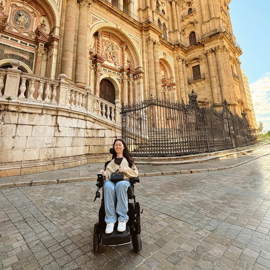 Tori Hunter, a wheelchair user and travel and lifestyle content creator visiting Malaga, Spain.