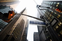 People cross Bay St. in Toronto's Financial District on Tuesday, January 6, 2026.  