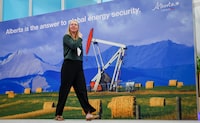 A delegate walks past a display at the Global Energy Show in Calgary, Tuesday, June 9, 2026.THE CANADIAN PRESS/Jeff McIntosh