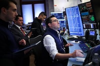 Traders work on the floor of the New York Stock Exchange (NYSE) before the closing bell in New York City on April 8, 2026. Wall Street stocks surged on April 8, joining a global equity rally after the US-Iran truce sent oil prices sharply lower. The Dow Jones Industrial Average finished at 47,909.92, rising more than 1,300 points or 2.9 percent. (Photo by CHARLY TRIBALLEAU / AFP via Getty Images)