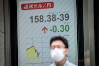 A man walks past an electronic quotation board displaying the foreign exchange rate of the Japanese yen against the US dollar in Tokyo on September 3, 2026. (Photo by Yuichi YAMAZAKI / AFP via Getty Images)