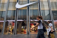 SHENZHEN, CHINA - APRIL 12: Pedestrians walk past a Nike store with a prominent logo on display at a retail shopping district, while shoppers can be seen inside browsing apparel and footwear products, on April 12, 2025 in Shenzhen, China. China has imposed a new round of retaliatory tariffs on U.S. imports, raising duties to 125% in response to the latest escalation by the United States, which increased tariffs on Chinese goods to 145%. The growing trade tensions have further impacted China's export sector, affecting key industries such as logistics, manufacturing, and cross-border e-commerce. The measures are part of Beijing's broader strategy to counter rising economic pressure and defend its trade interests. (Photo by Cheng Xin/Getty Images)