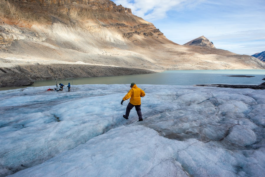 John Pomeroy walks across Peyto Glacier in Alberta on Sept. 4, 2024. The hydrologist has studied this glacier since 2008, documenting it as it melts.