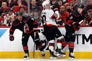 Ottawa Senators' Fabian Zetterlund (20) collides with Carolina Hurricanes' Seth Jarvis (24) and Alexander Nikishin (21) the first period of Game 2 of an NHL hockey Stanley Cup first-round playoff series in Raleigh, N.C., Monday, April 20, 2026. (AP Photo/Karl DeBlaker)