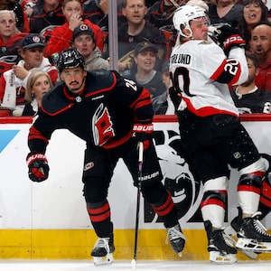 Ottawa Senators' Fabian Zetterlund (20) collides with Carolina Hurricanes' Seth Jarvis (24) and Alexander Nikishin (21) the first period of Game 2 of an NHL hockey Stanley Cup first-round playoff series in Raleigh, N.C., Monday, April 20, 2026. (AP Photo/Karl DeBlaker)
