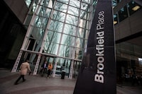 FILE PHOTO: People walk to Brookfield Place off Bay Street on the day of the annual general meeting for Brookfield Asset Management shareholders in Toronto, May 7, 2014.  . REUTERS/Mark Blinch/File Photo