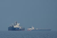 Oil tankers and cargo ships line up in the Strait of Hormuz as seen from Mina Al Fajer, United Arab Emirates, Wednesday, March 11, 2026. (AP Photo/Altaf Qadri)