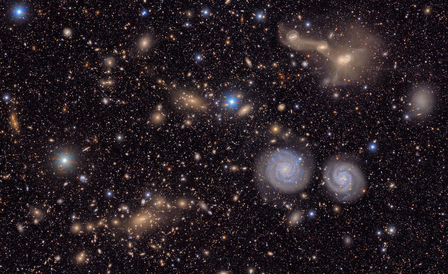 This image shows a small section of the Rubin Observatory's total view of the Virgo cluster, a massive swarm of galaxies located approximately 65 million light years from the Milky Way. Prominent in the image are two spiral galaxies seen face-on (lower right) and three galaxies in the process of merging (upper right). Individual stars in the image are in the foreground and belong to our own Milky Way galaxy. What makes the observatory's images exceptional is the breadth of field combined with the ability to reveal distant objects in stunning detail.  