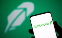 FILE PHOTO: Robinhood logo is seen on a smartphone in front of a displayed same logo in this illustration taken, July 2, 2021. REUTERS/Dado Ruvic/Illustration/File Photo
