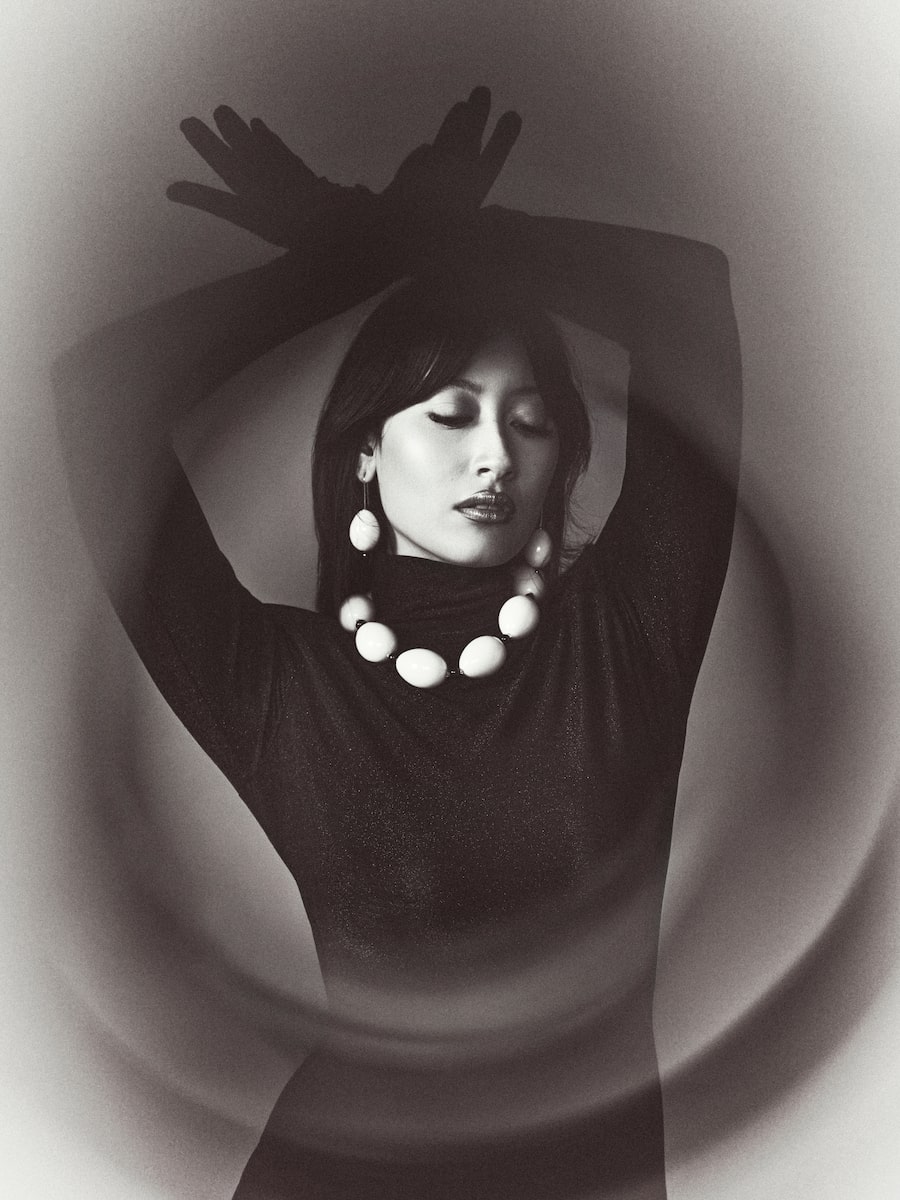 HIGH CONTRAST: Baubles pop on a silhouette that’s otherwise all black, from fingertip to toe. Beaufille gown with glove sleeves through beaufille.com. Gohar World porcelain egg necklace, earrings through gohar.world.