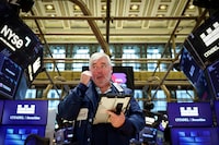 FILE PHOTO: Traders work on the floor at the New York Stock Exchange (NYSE) in New York City, U.S., March 2, 2026.  REUTERS/Brendan McDermid/File Photo