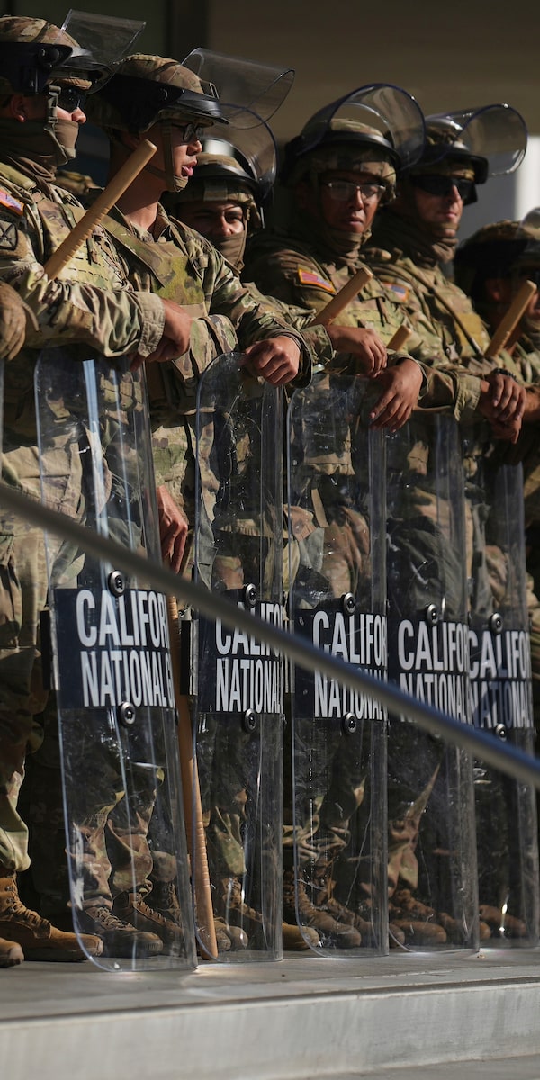 National Guard members surround a federal building in Los Angeles on Tuesday, hours before a curfew in the downtown core and a wave of mass arrests. Since last week’s furor over a new round of immigration raids in California, U.S. President Donald Trump has sent thousands of troops to the state.