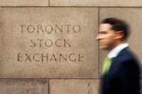 A man walks past an old Toronto Stock Exchange (TSX) sign in Toronto, June 23, 2014. 