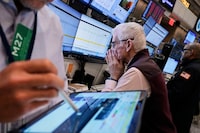 Trader Peter Herits, center, works on the options floor of the New York Stock Exchange, Thursday, April 10, 2025. (AP Photo/Richard Drew)