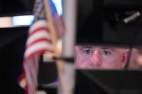 People work on the floor at the New York Stock Exchange in New York, Monday, April 13, 2026. (AP Photo/Seth Wenig)
