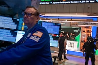 Traders work on the floor of the New York Stock Exchange on November 21, 2025 in New York City. 