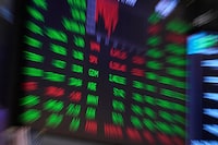 A board above the trading floor of the New York Stock Exchange is shown in this image, Tuesday, July 1, 2025.  