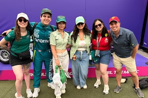 Jonah Presser, a Lance Stroll lookalike, poses with fans.