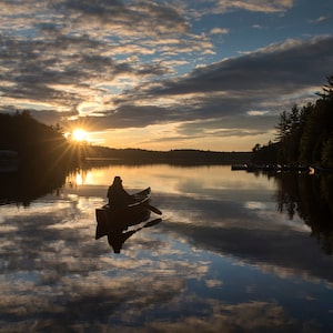 Olivia Gerelus goes for a sunset paddle in Algonquin Park Friday June 11, 2021. With provincial re-opening people from across Ontario flocked to Ontario's marquee provincial park. THE CANADIAN PRESS/Fred Thornhill