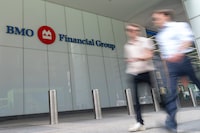 People make their way past the Bank of Montreal (BMO) building in Toronto's financial district, Monday, Aug. 14, 2023. THE CANADIAN PRESS/Spencer Colby
