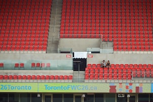 People sit in the empty stands at BMO Field as the City of Toronto and MLSE complete the first phase of upgrades in transforming the space into the 2026 World Cup ready Toronto Stadium in Toronto, on Tuesday, Sept. 23, 2025. THE CANADIAN PRESS/Sammy Kogan