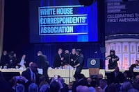 U.S. Secret Service agents surround President Donald Trump as he is taken from the stage after a shooting incident during the White House Correspondents Dinner, April 25.